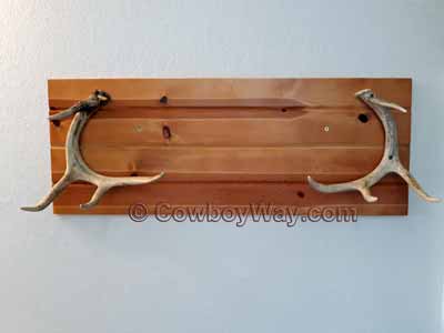 A towel rack with two antlers