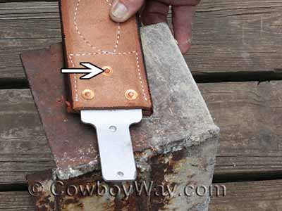 Close-up photo of three rivets in a stirrup leather