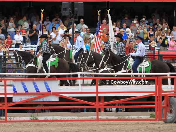 The flag of the United States of America, 
accompanied by a mounted color guard