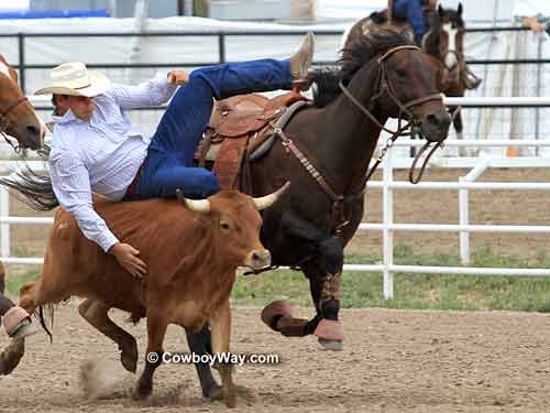 Seth Brockman gets down on his steer