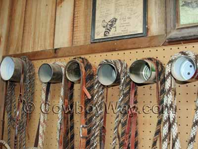 A row of bridles hanging on a can bridle rack