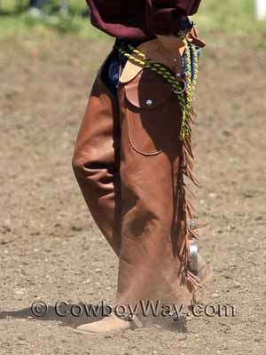 A young boy wearing shotgun chaps