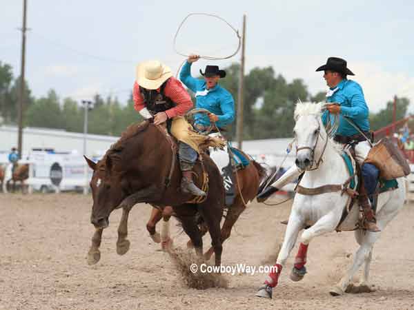 Pickup men move in after a bronc ride Pickup men move in after a bronc ride