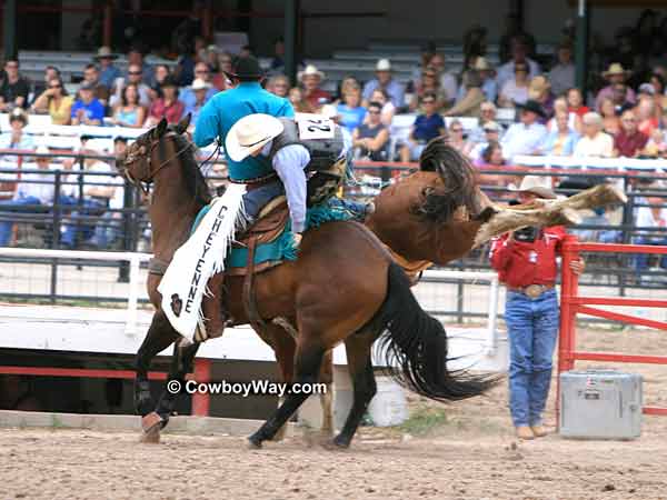 Saddle bronc rider Jacobs Crawley 
gets off bronc Justins Angel