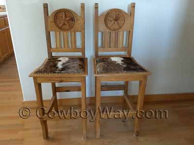 Two hair-on-hide cowhide bar stools