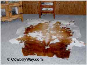 A cowhide rug on carpet