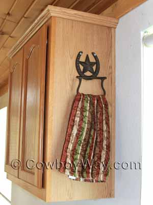 A cowboy towel holder made from a horseshoe