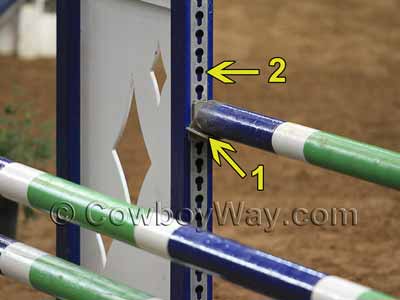 Close-up photo of jump standards showing keyhole tracks