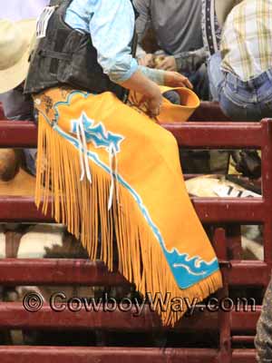 Rodeo chaps with a bright color, long frine, and contrasting accents