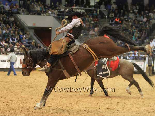 Wes Housler rides a bay bronc