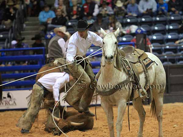 A member of the Angell Ranch team makes a flying dismount in the stray gathering event