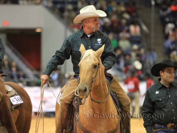 A man on a horse waits to rope