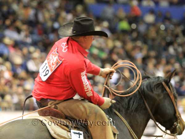 A roper takes a calf to be branded