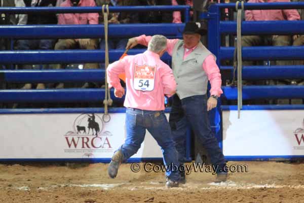 Taking the milk to the judge in the wild cow milking event