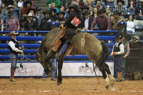 Wes Bailey rides a ranch bronc standing in one stirrup