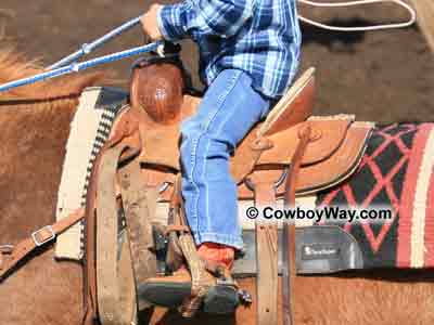 A child riding in a youth saddle