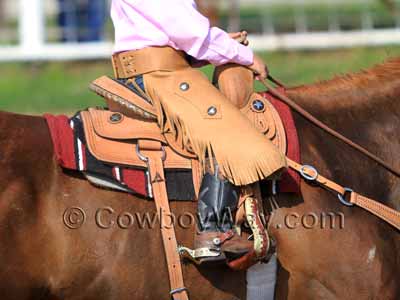 A young rider in a youth saddle