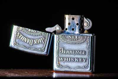 A Zippo with a Jack Daniels design