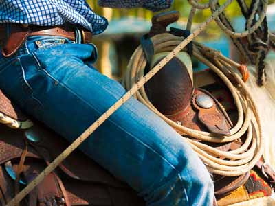 A Billy Cook saddle with rider and rope.