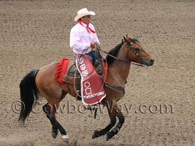 A rodeo pickup man wearing batwing chaps