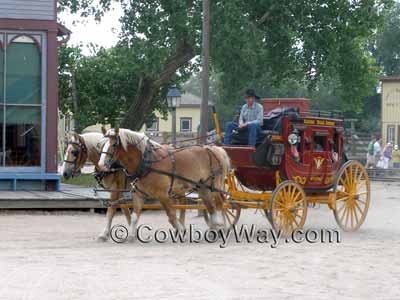 A harnessed team of Belgian draft horses pull a stagecoach