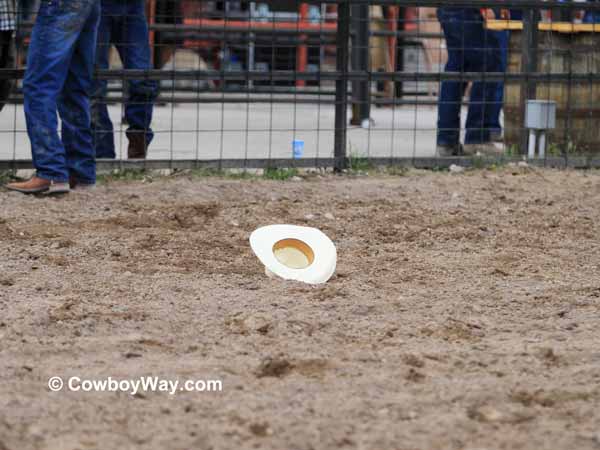 A cowboy hat in the dirt