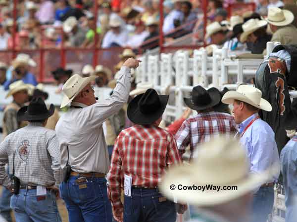 In front of the bucking chutes, 
Cheyenne Frontier Days Rodeo