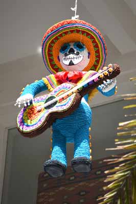 A cowboy pinata playing a guitar