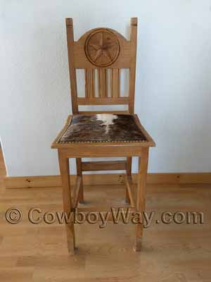 A cowhide bar stall with a wooden back