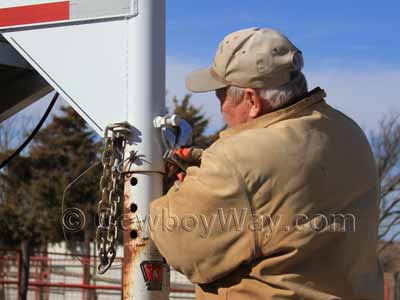 Loosening the nut on a trailer coupler