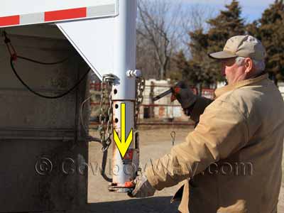 Removing the pin on a gooseneck trailer coupler