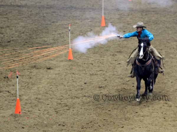 A cowboy shooter mounted on a black horse