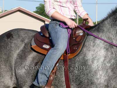 A saddle on a gray draft horse