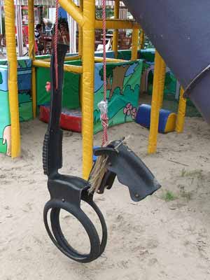 A horse tire swing in a playground