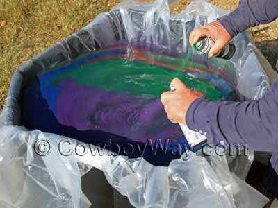Spraying paint onto the surface of the water