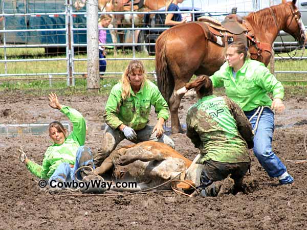A women's ranch rodeo team completes the tie-down event