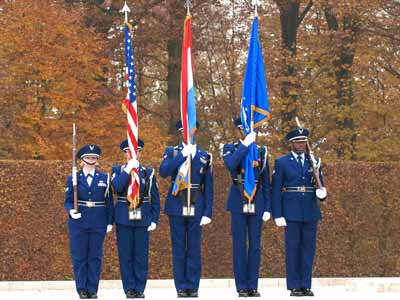 Five members of a military Color Guard stand at attention