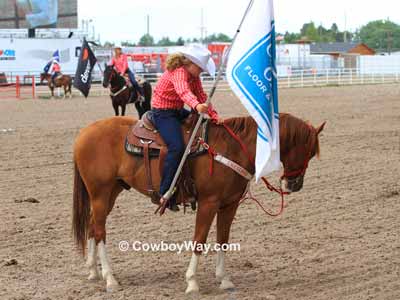 A sponsor flag is dipped in respect when the colors are posted at a rodeo