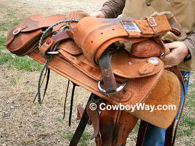 Lay the cinches, etc. across the saddle seat