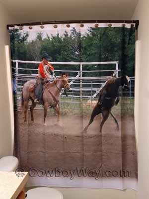 A shower curtain with a Western theme