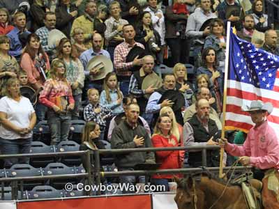 The United States flag being formall presented at a ranch rodeo