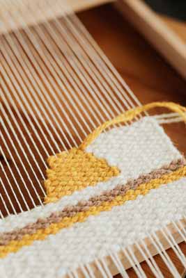 Hand weaving a tapestry